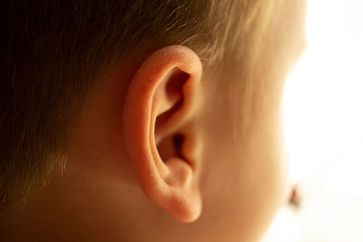 Close-up of boy against white background