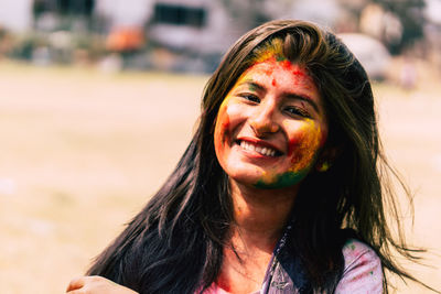 Close-up portrait of smiling young woman