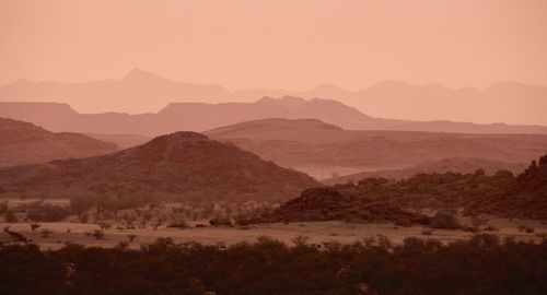 Scenic view of landscape against sky during sunset