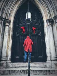 Rear view of man standing by church door