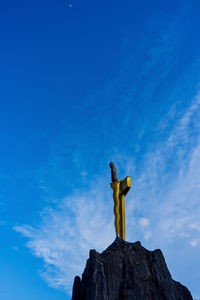 Low angle view of statue against rock