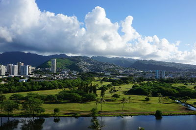 Scenic view of lake and buildings against sky