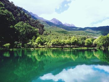 Scenic view of lake and mountains against sky