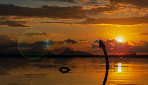 Scenic view of sea against orange sky