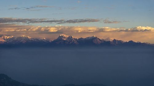 Scenic view of snowcapped mountains against sky during sunset