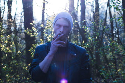 Portrait of young man in forest