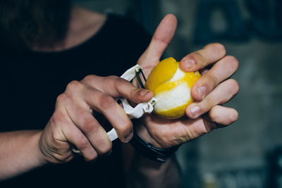 Barman preparing a cocktail with lemon in the bar.