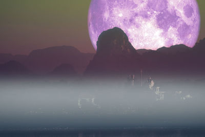 Scenic view of silhouette mountain against sky at night