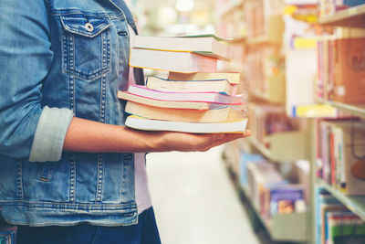 Midsection of woman reading book