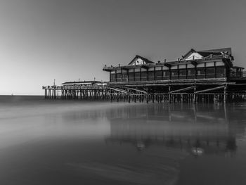 Pier over sea against clear sky