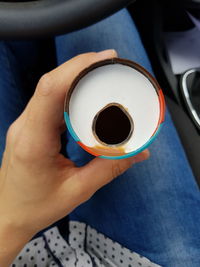 High angle view of hand holding coffee cup