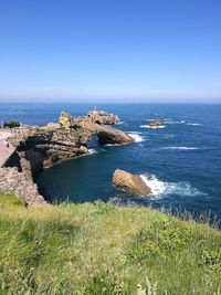 Scenic view of sea against clear blue sky