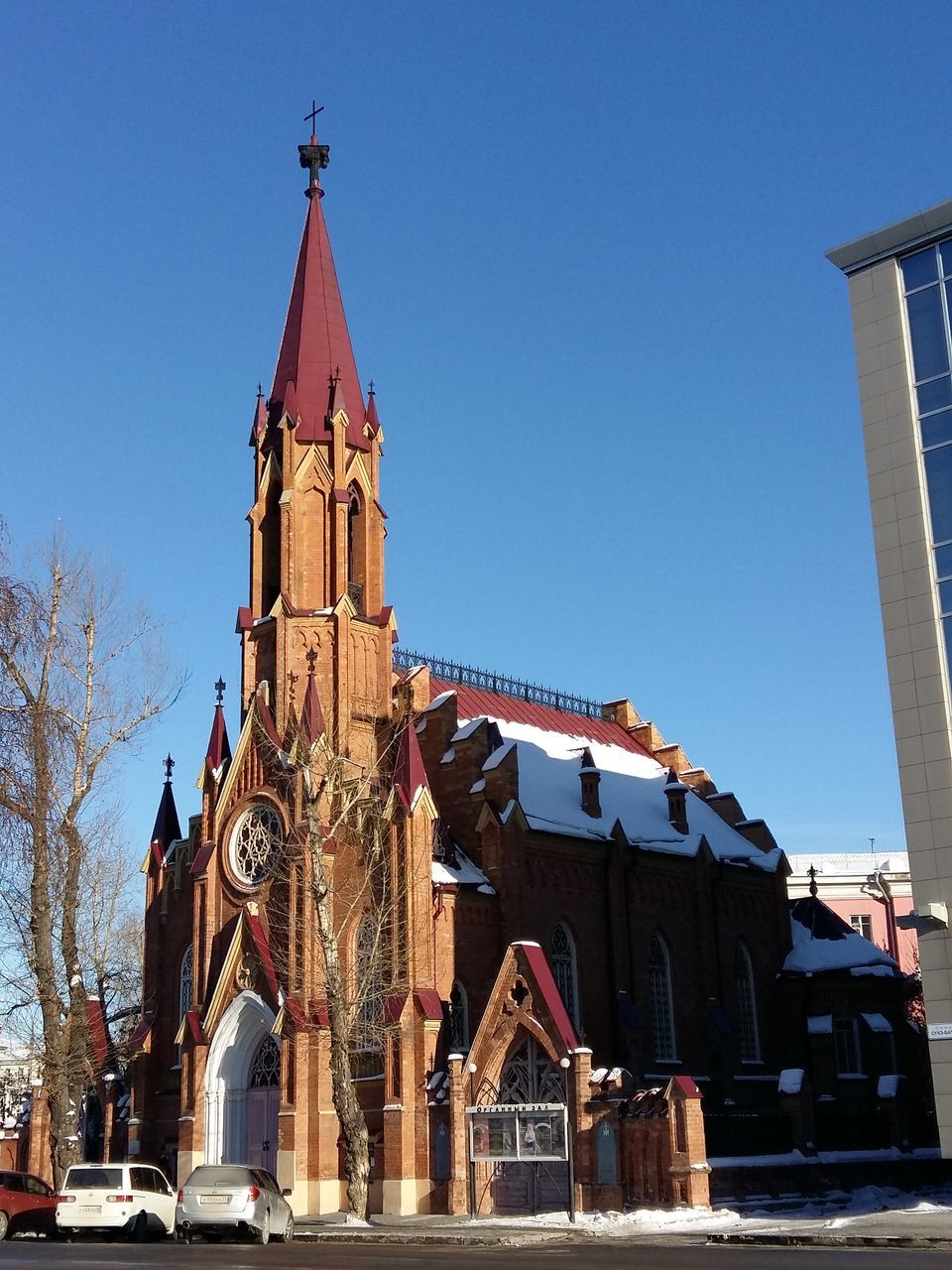 clear sky, sky, blue, architecture, building exterior, built structure, tower, clock tower, christmas, tree, outdoors, no people, clock, christmas tree, statue, day, astronomical clock