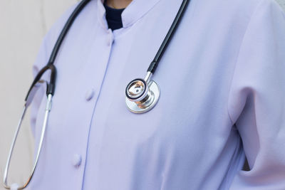 Midsection of doctor with stethoscope in office