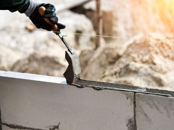 Bricklayer industrial worker installing brick masonry cement