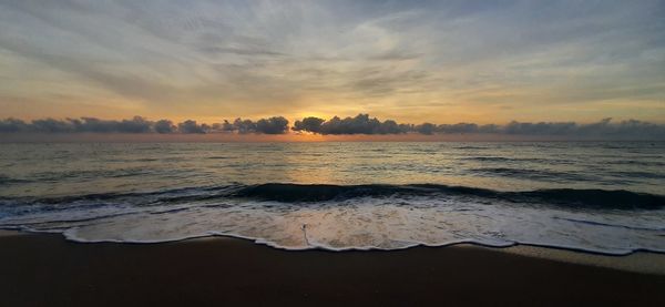 Scenic view of beach against sky during sunset