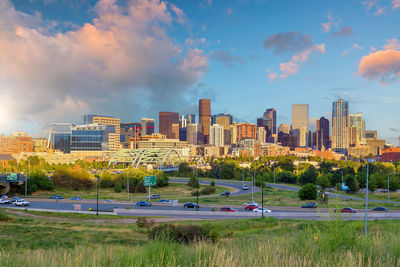 Buildings in city against sky during sunset