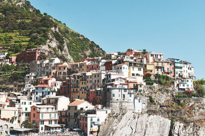 Buildings in town against clear sky