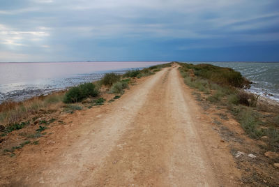 Road by sea against sky