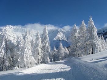 Panoramic shot of snow covered mountain against sky