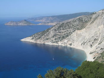 High angle view of sea and mountains against sky