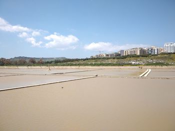 Scenic view of beach against sky in city