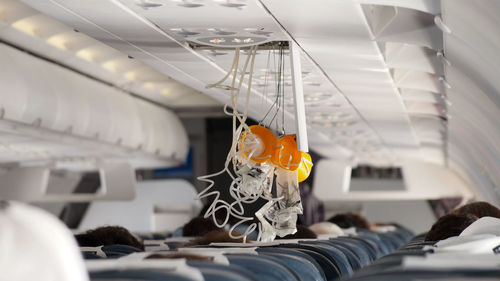 Close-up of gas mask hanging in airplane