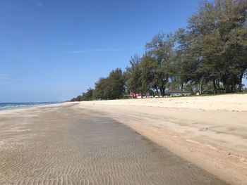 Scenic view of beach against blue sky