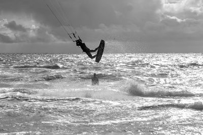 Silhouette kite surfing in the ocean