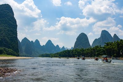 Scenic view of sea and mountains against sky