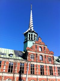 Low angle view of building against clear blue sky