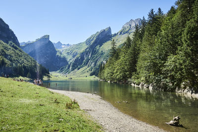 Scenic view of lake and mountains against clear sky