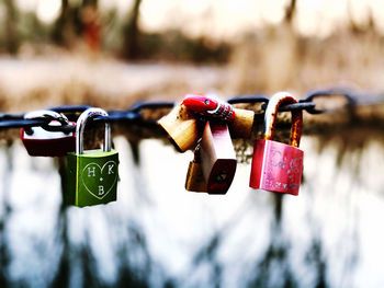 Close-up of padlocks hanging on railing