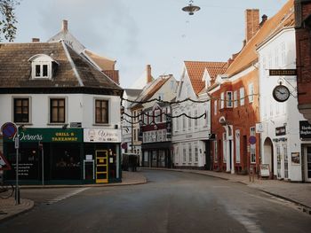 Street amidst buildings against sky