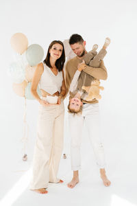Full length of couple standing against white background