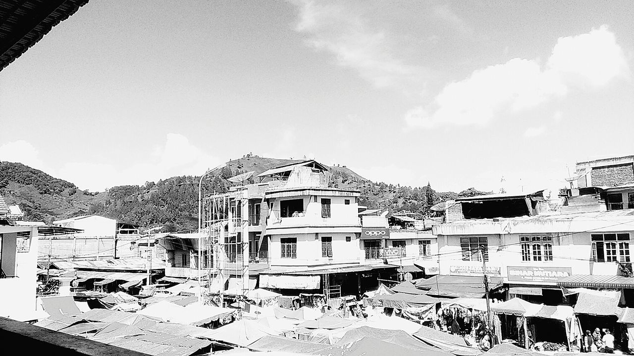 building exterior, architecture, sky, built structure, day, car, outdoors, cloud - sky, mountain, snow, large group of people, city, real people, awning, nature, people