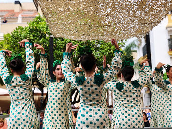 Group of people standing against plants