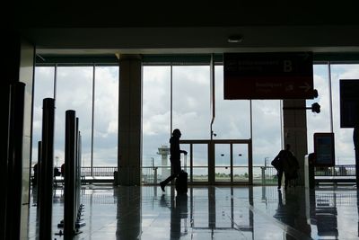 Silhouette people at railroad station platform