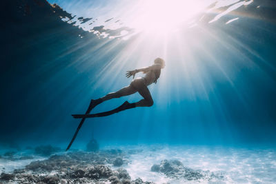 Low angle view of man swimming in sea