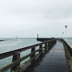 Long walkway leading to calm sea