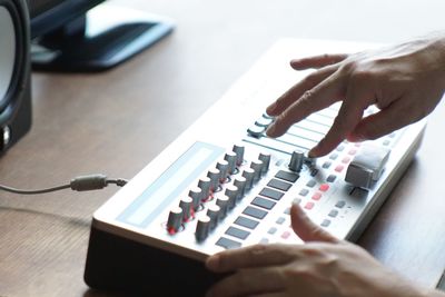 Midsection of man using mobile phone on table