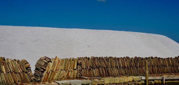 Low angle view of stack against blue sky