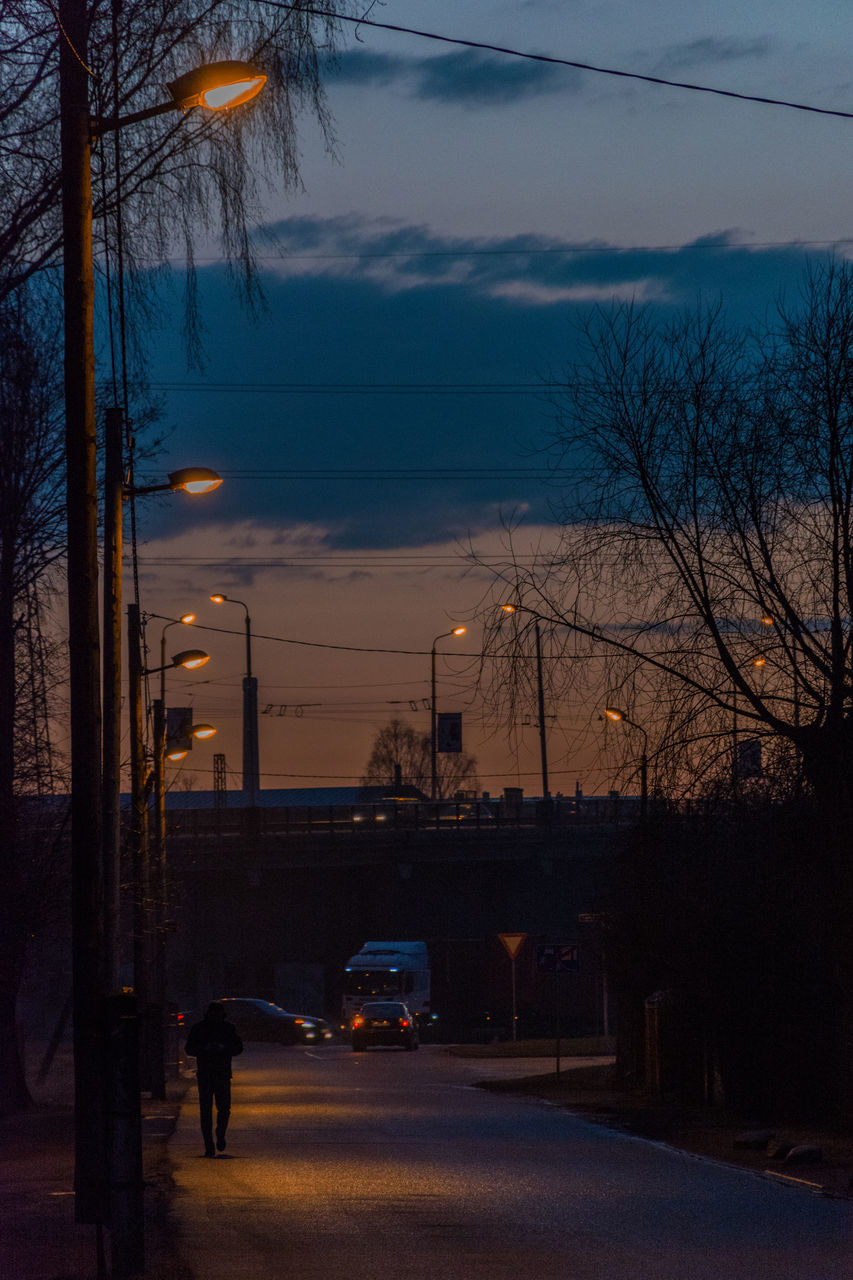 CARS ON ROAD AT DUSK