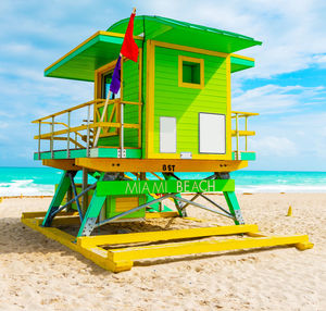 Lifeguard hut on beach against sky