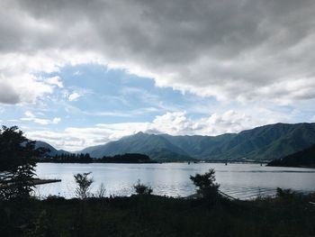 Scenic view of lake and mountains against sky