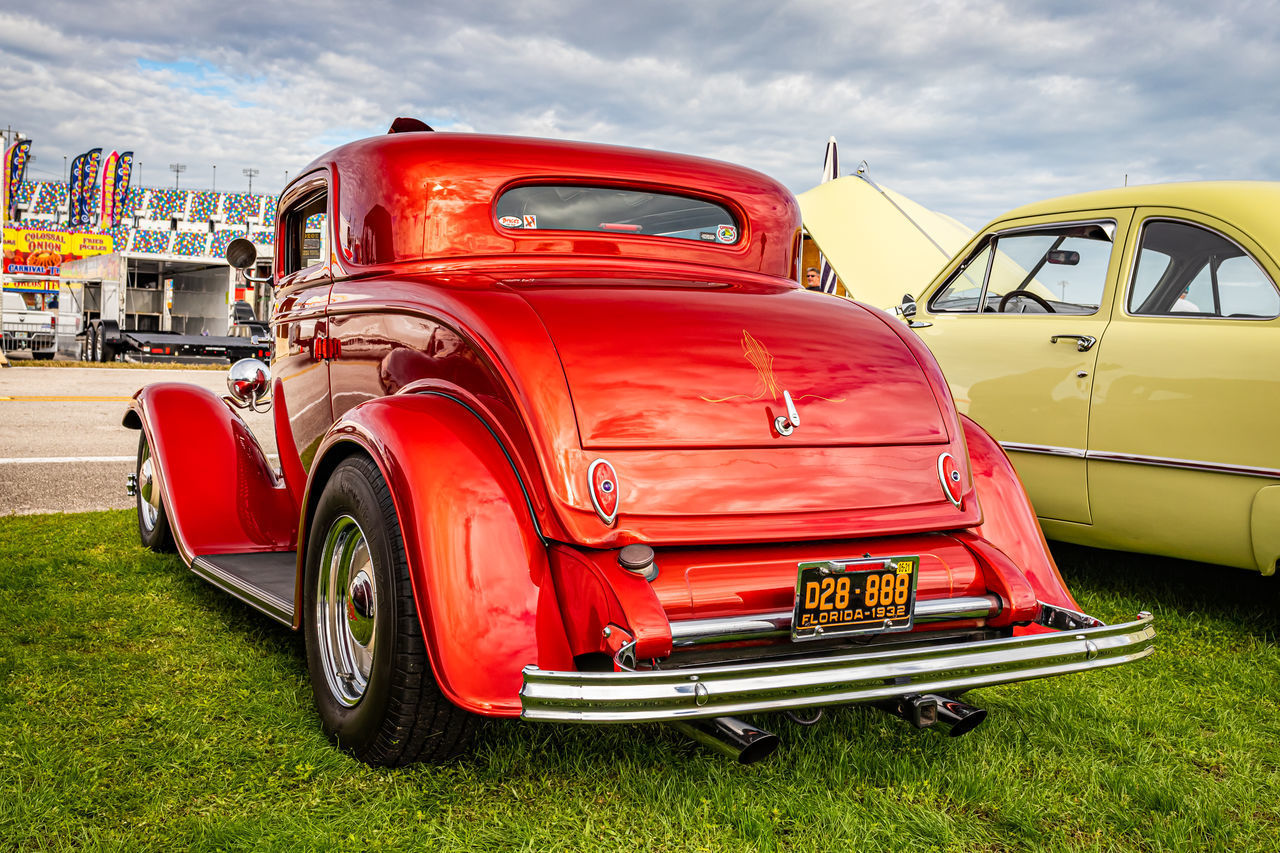 RED VINTAGE CAR AGAINST SKY