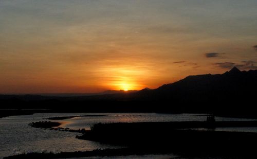 Scenic view of lake against romantic sky at sunset