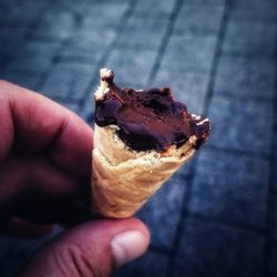 Close-up of hand holding ice cream