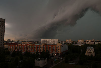 View of cityscape against storm clouds