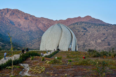 Scenic view of land and mountains against clear sky